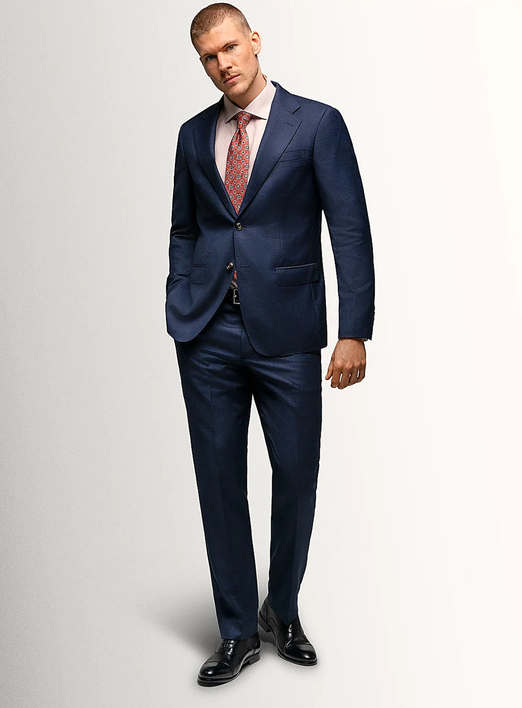 Angled view of the navy jacket and matching trousers