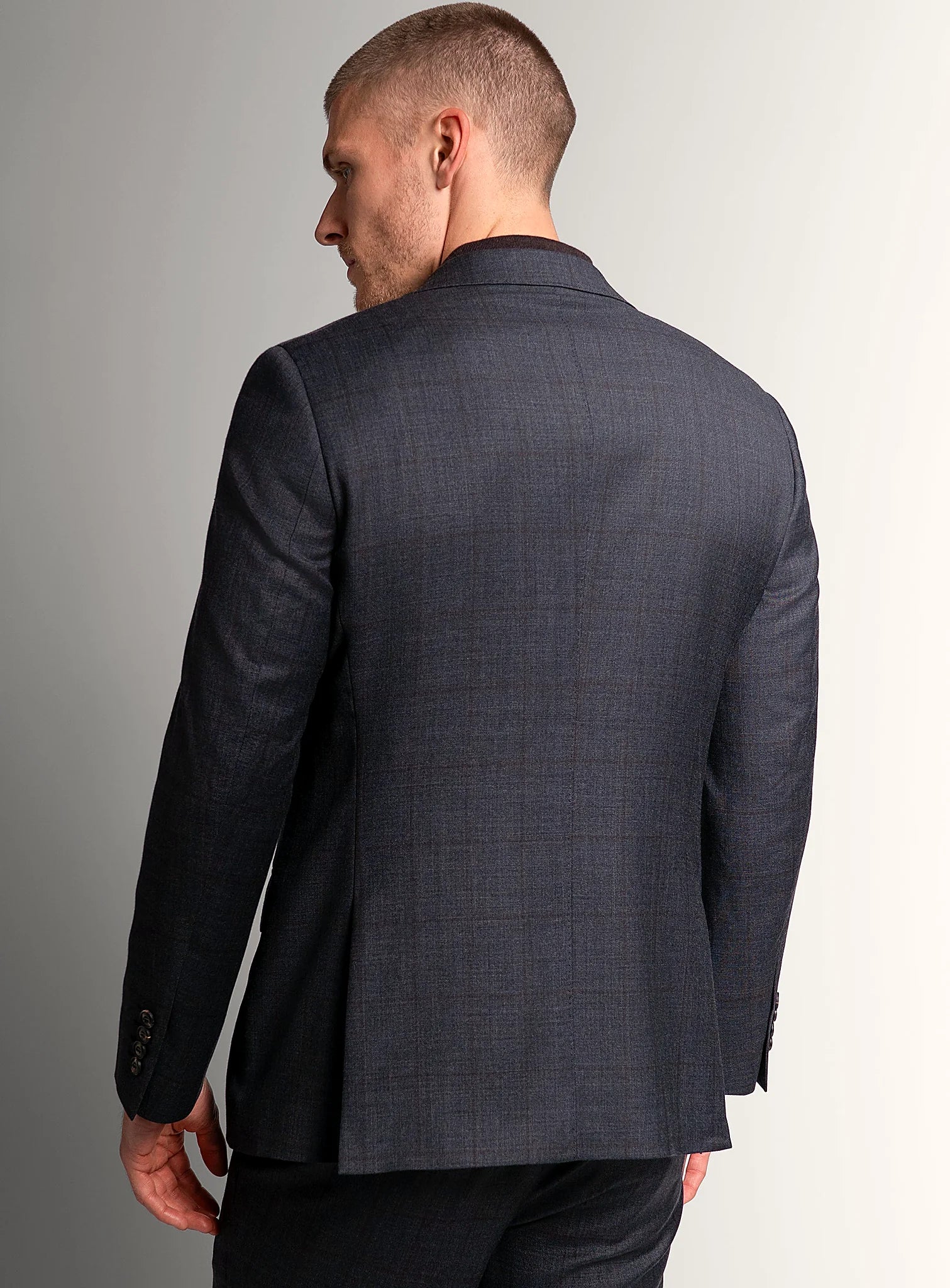 Notch lapel detail of the charcoal suit jacket