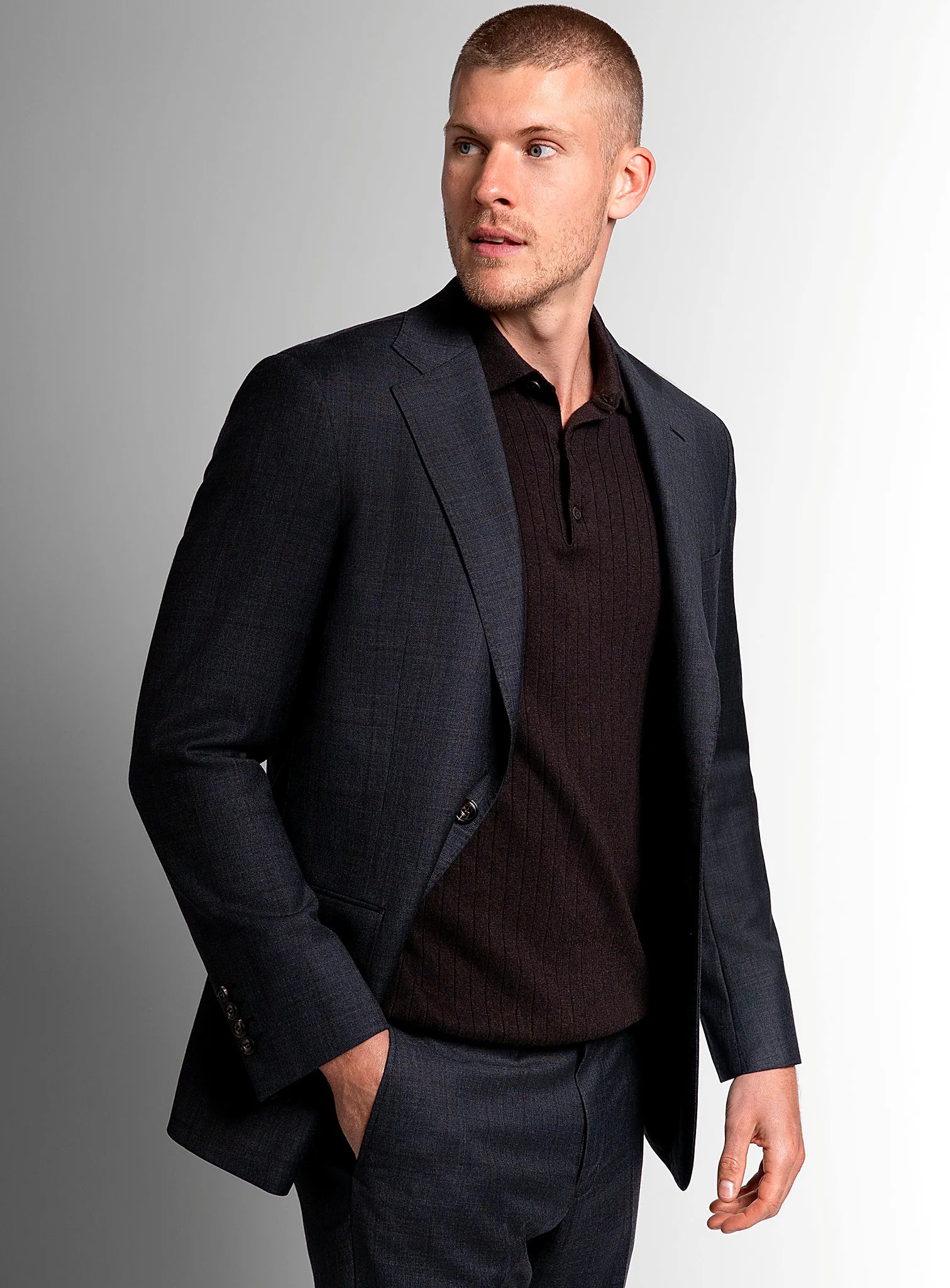Charcoal overcheck suit shown full length with a white shirt