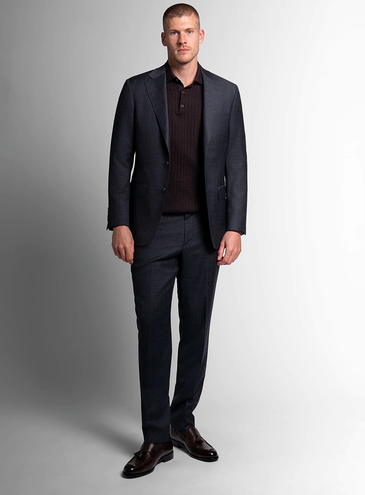 Three-quarter view of the charcoal jacket and trousers