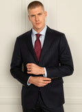 Navy pinstripe suit shown full length on a model