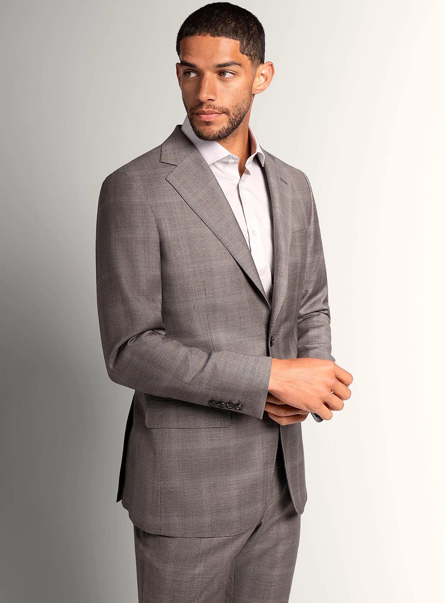 Taupe brown plaid suit shown full length on a model