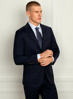 Navy windowpane suit worn full length with a plain shirt