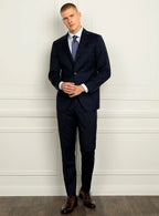 Angled view of the navy jacket and matching trousers