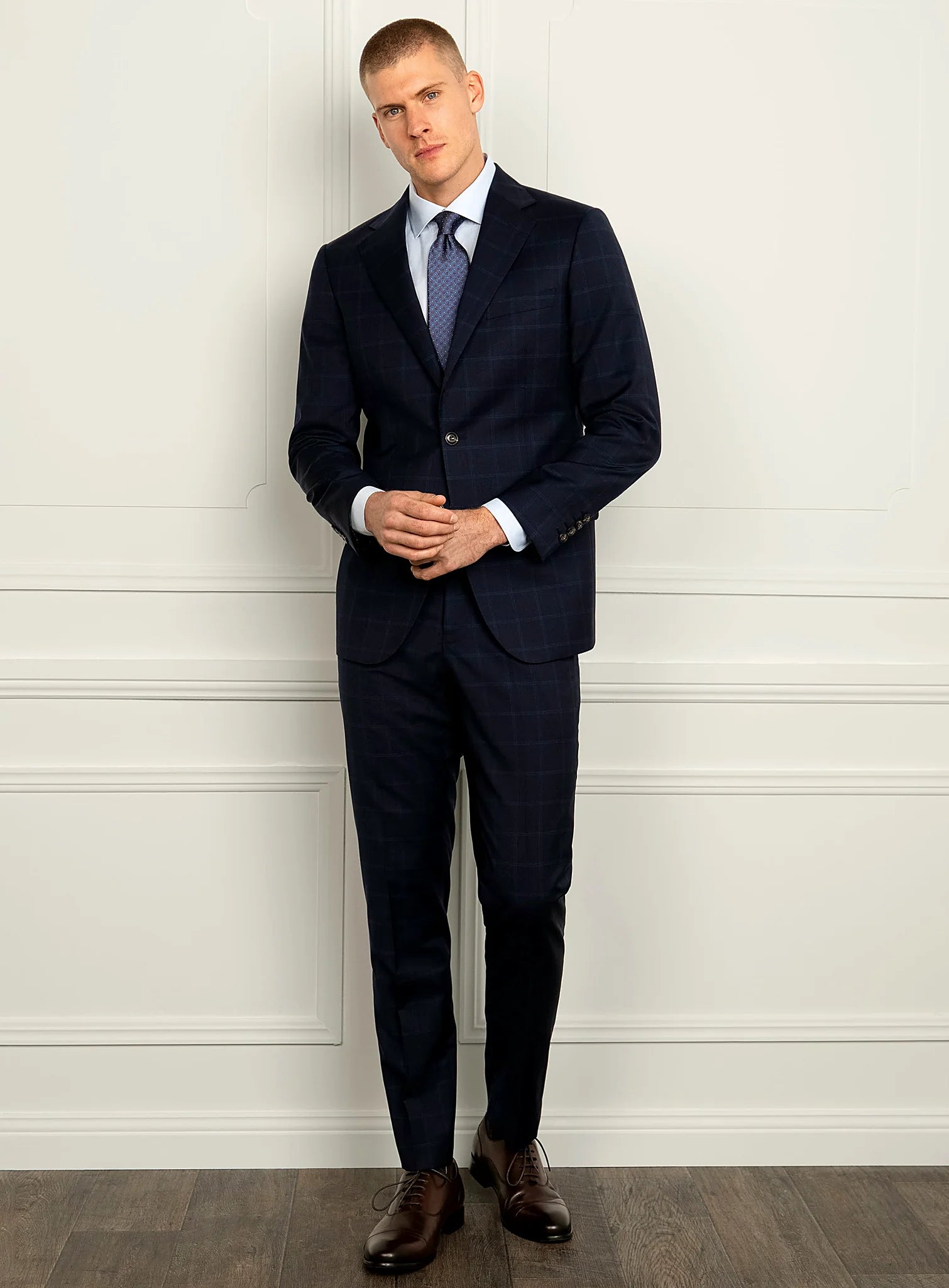 Angled view of the navy jacket and matching trousers
