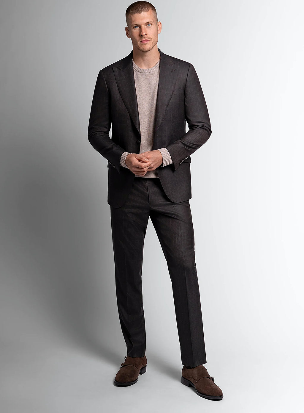 Three-quarter view of the brown jacket and trousers