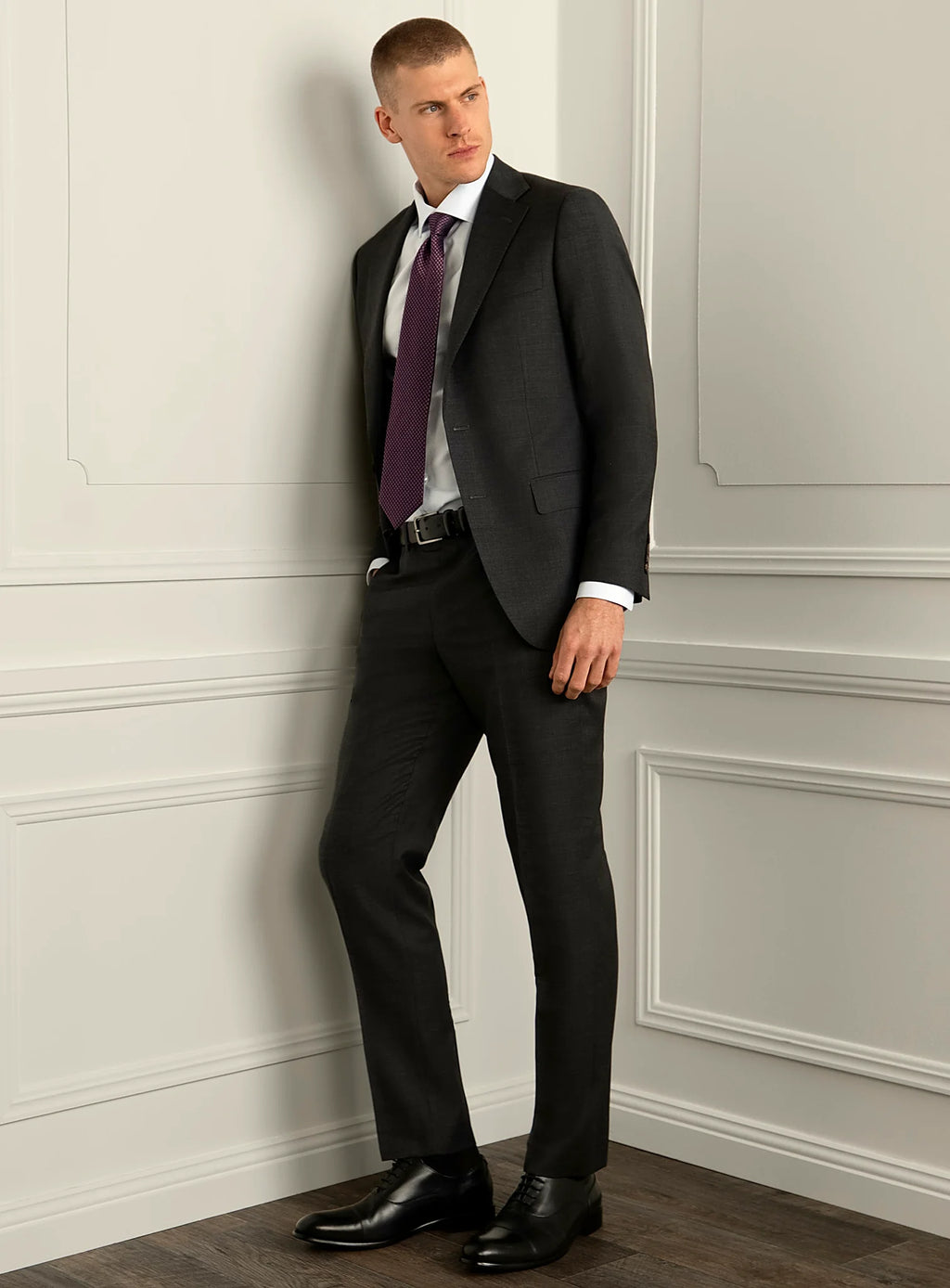 Three-quarter view of the charcoal jacket and trousers