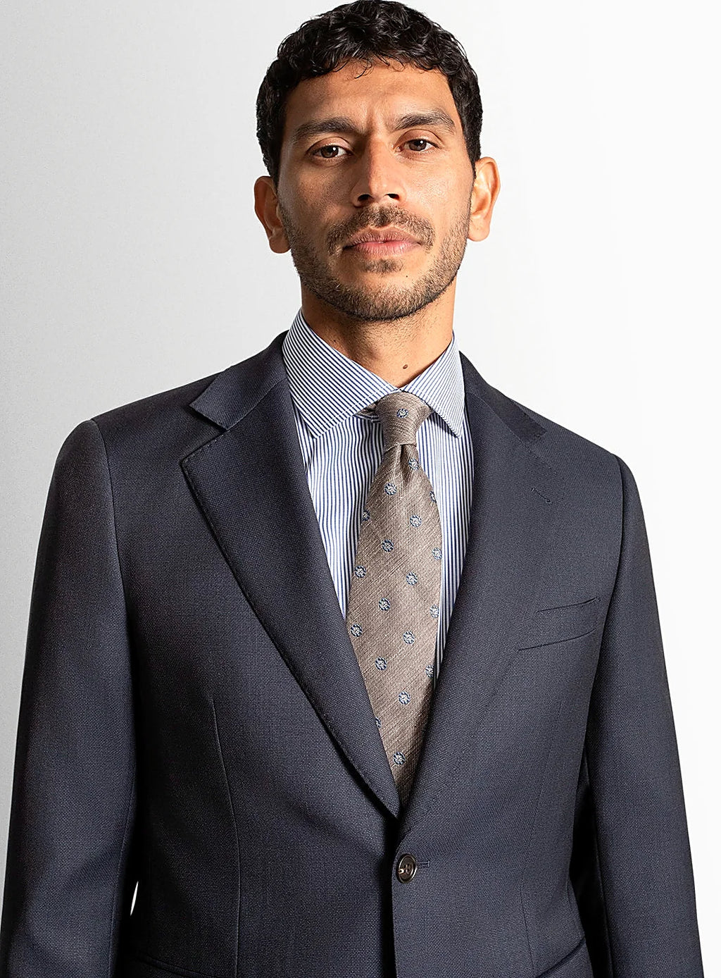 Collar and lapel detail of the navy suit jacket