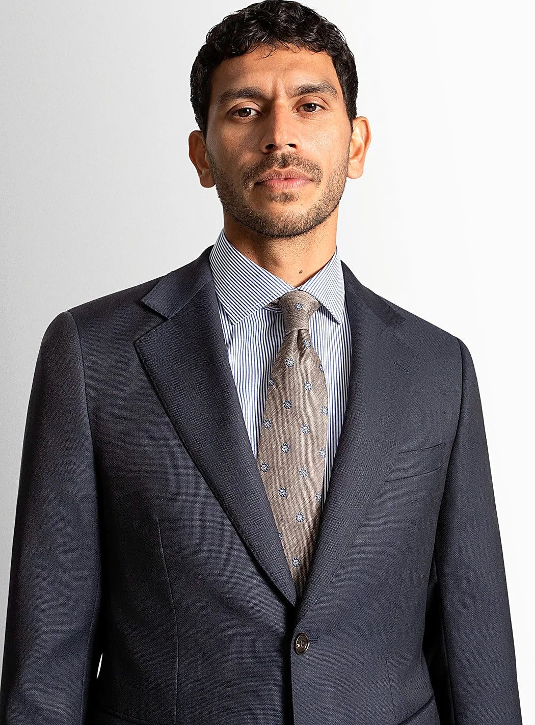 Collar and lapel detail of the navy suit jacket
