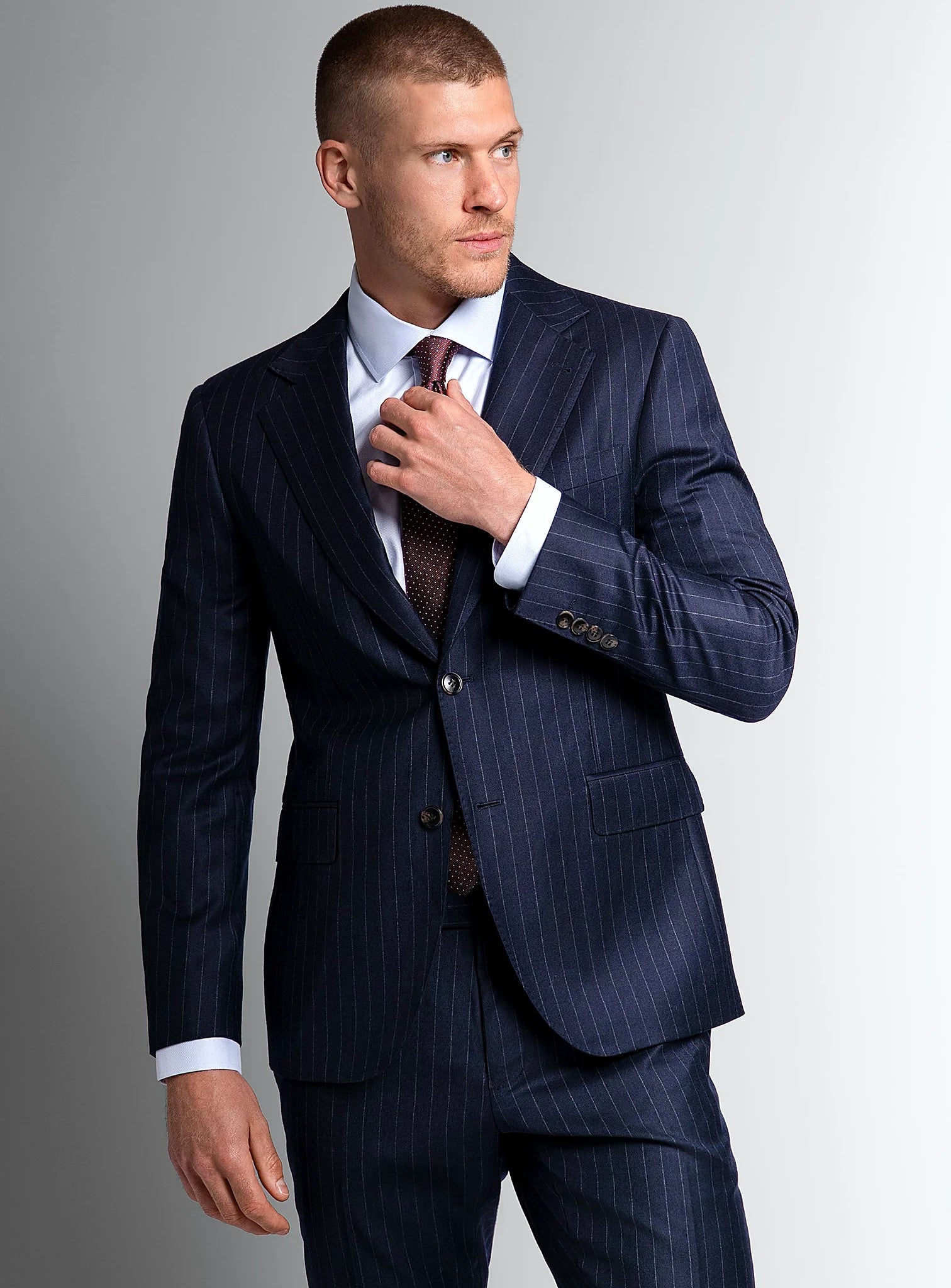 Navy wide pinstripe suit worn full length on a model