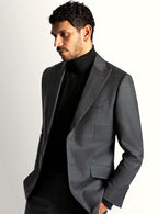 Notch lapel and flap pocket detail of the grey jacket