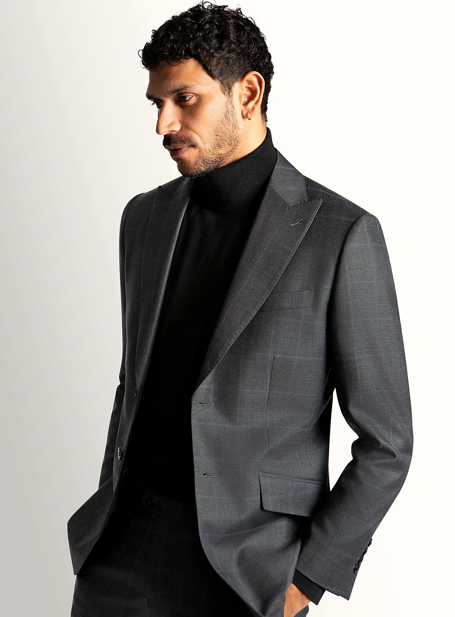 Notch lapel and flap pocket detail of the grey jacket
