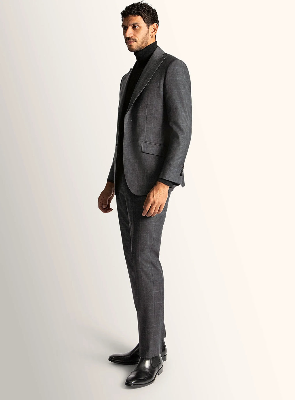 Three-quarter view of the grey jacket and trousers