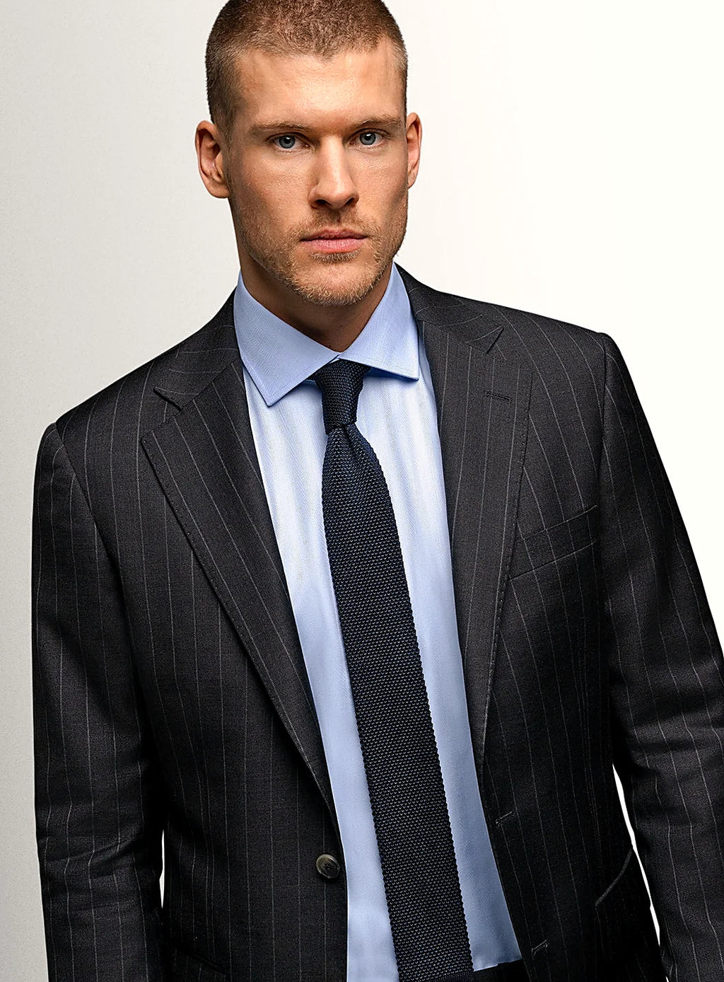 Lapel and buttoning detail of the charcoal jacket