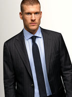 Lapel and buttoning detail of the charcoal jacket