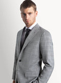 Grey plaid suit worn full length with an open collar