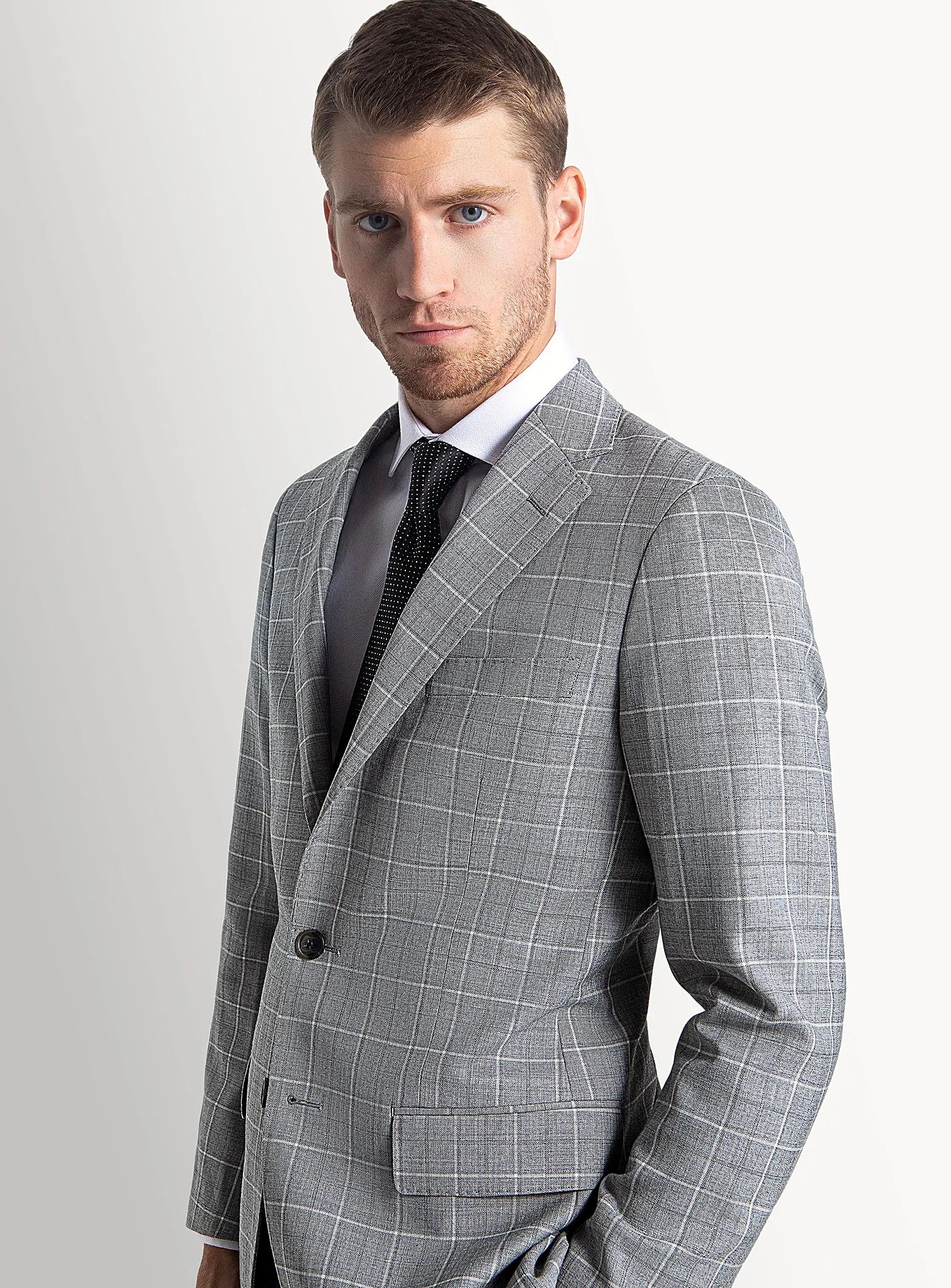 Grey plaid suit worn full length with an open collar
