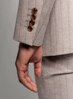 Peak lapel detail on the taupe suit jacket