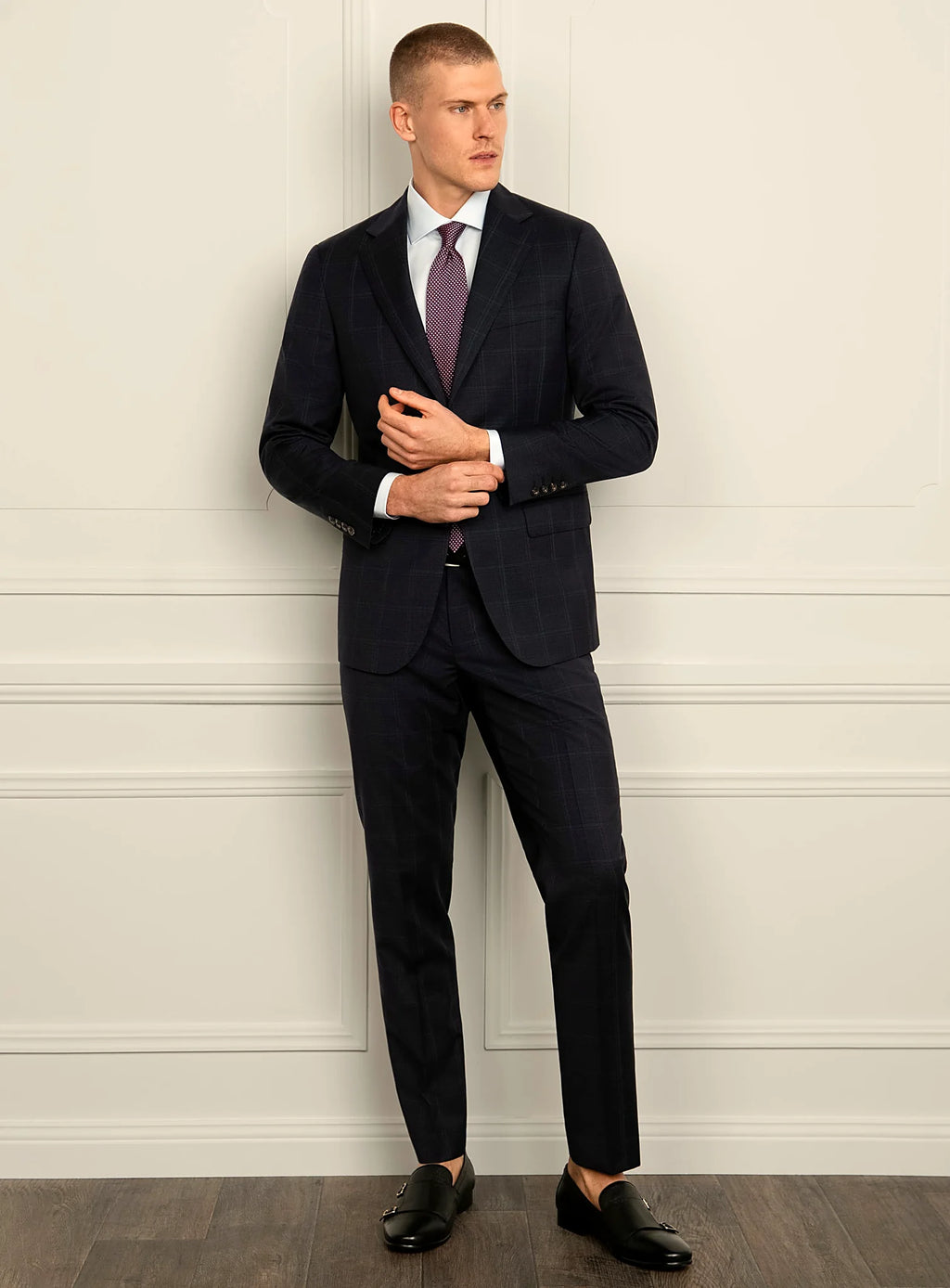 Angled view of the navy jacket and matching trousers