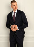 Navy tonal check suit shown full length with a tie
