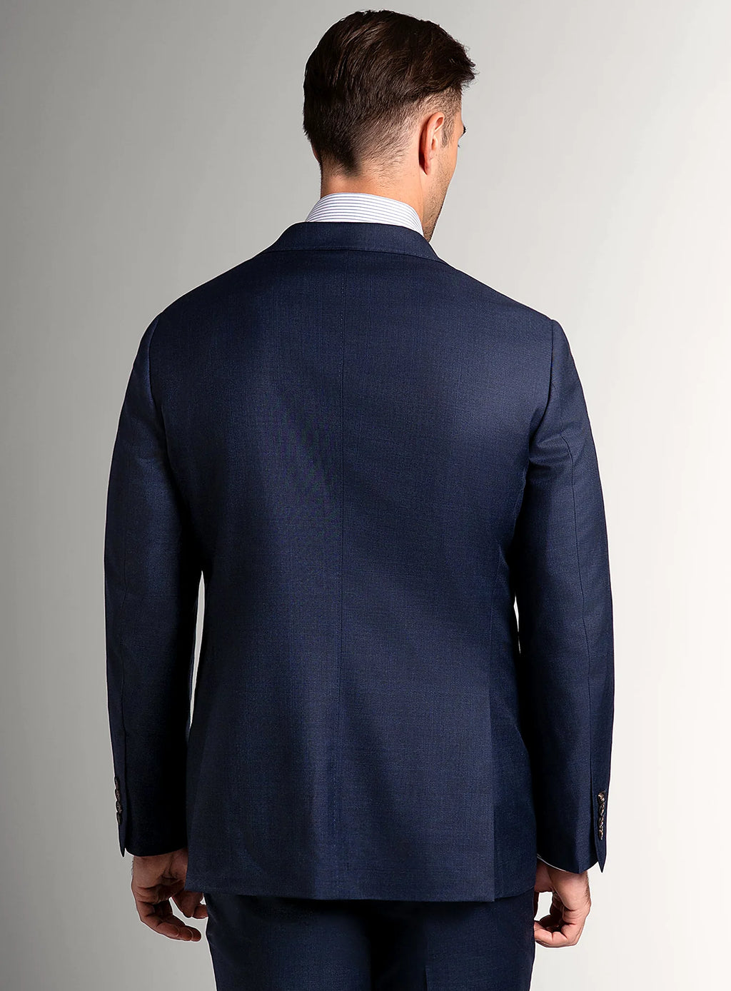 Notch lapel and flap pocket detail of the navy jacket