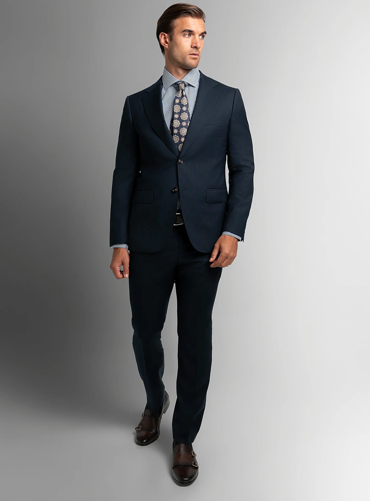 Three-quarter view of the navy jacket and trousers