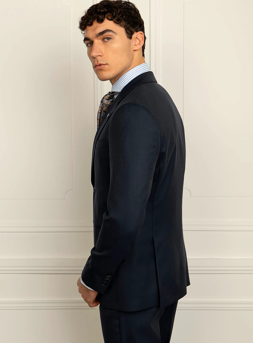 Lapel and collar detail of the navy suit jacket