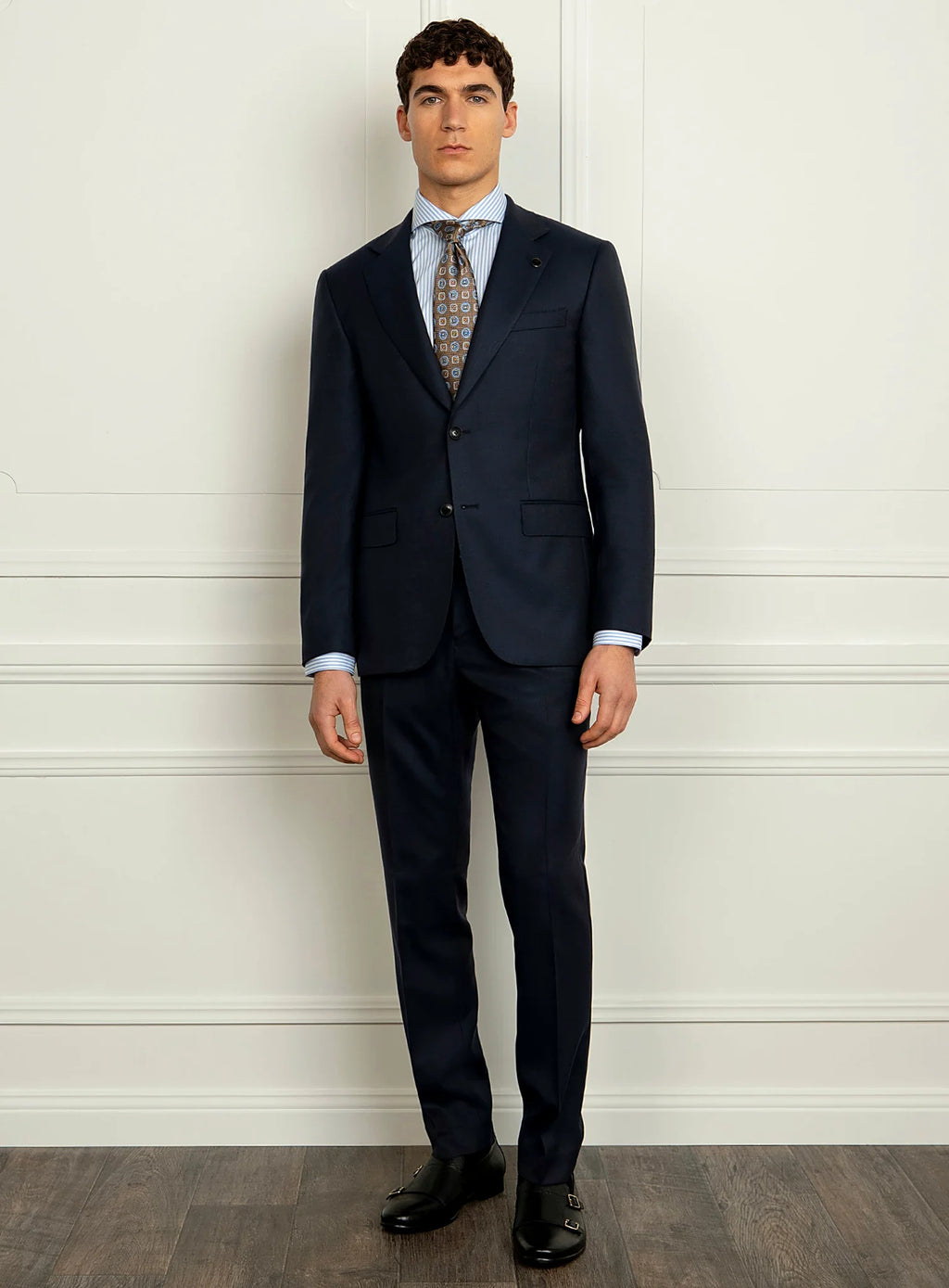 Three-quarter view of the navy jacket and trousers