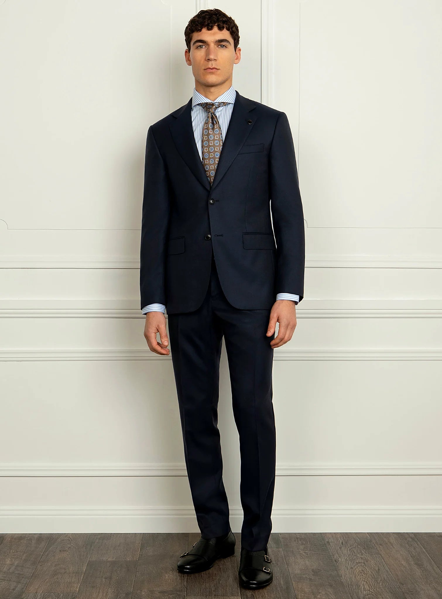 Three-quarter view of the navy jacket and trousers
