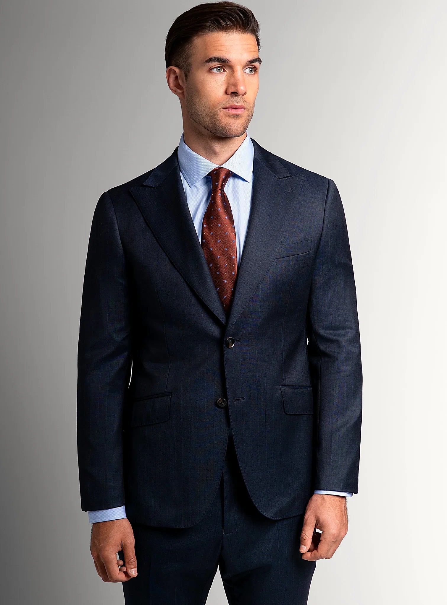 Navy peak lapel pinstripe suit shown full length