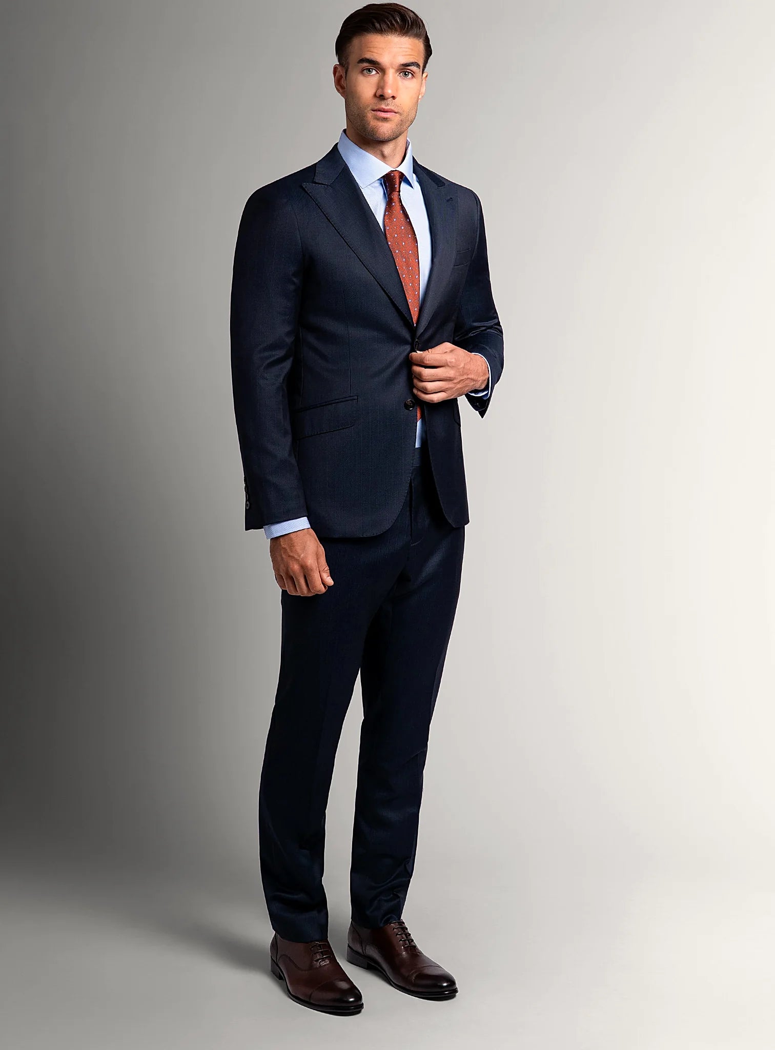 Three-quarter view of the navy jacket and trousers