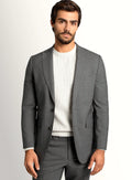 Mid grey suit shown full length with a crisp white shirt
