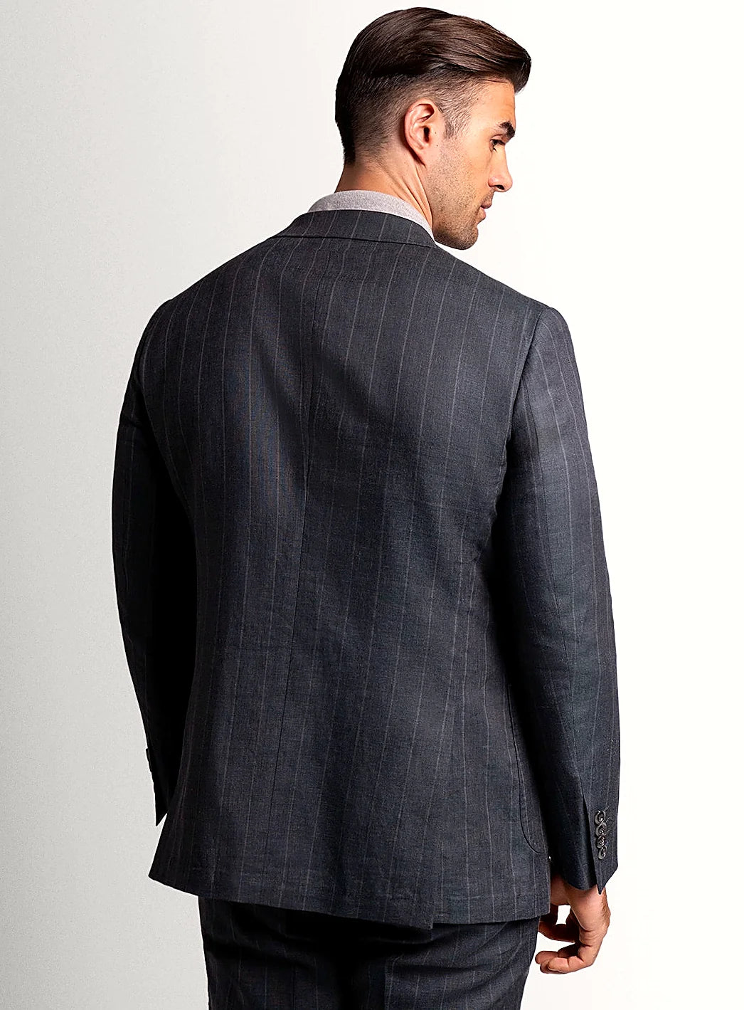 Lapel and chest pocket detail of the olive jacket