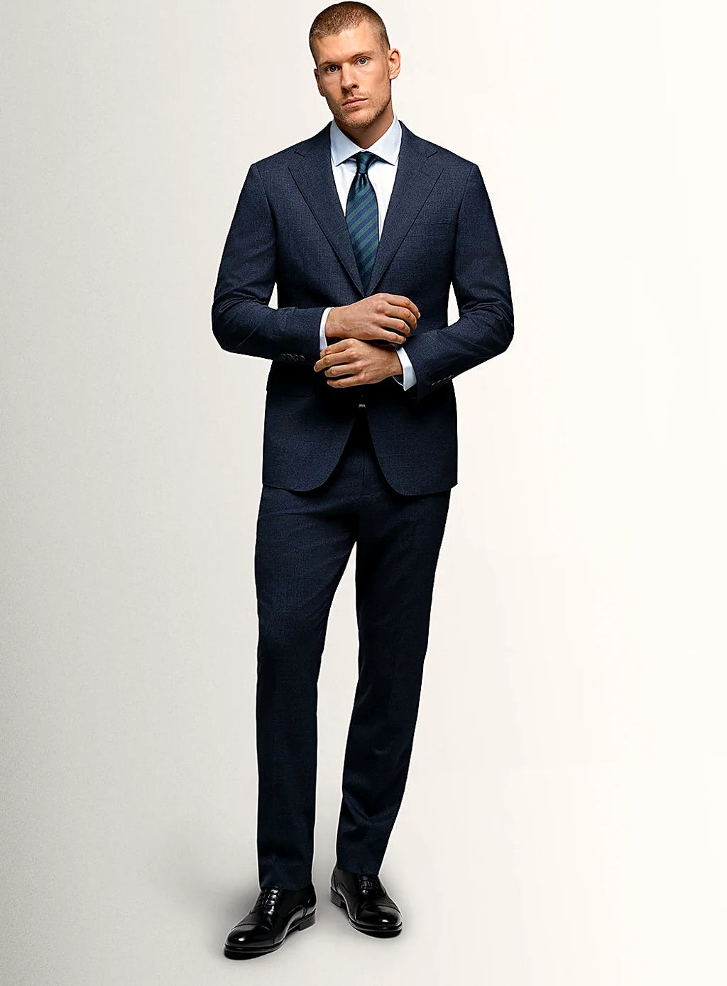 Angled view of the navy jacket and matching trousers