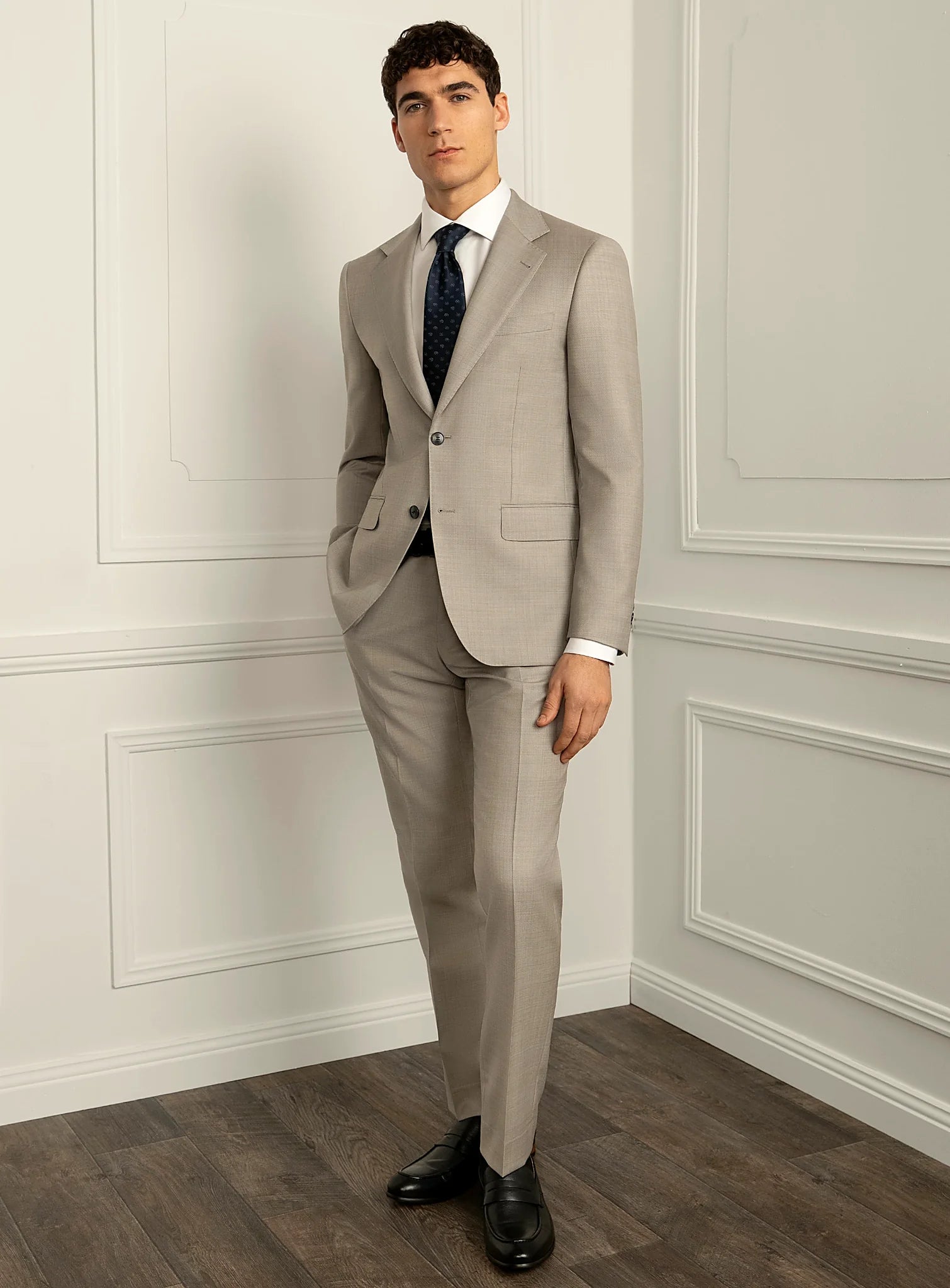 Three-quarter view of the beige jacket and trousers