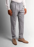 Silver pinstripe trousers shown full length on a model