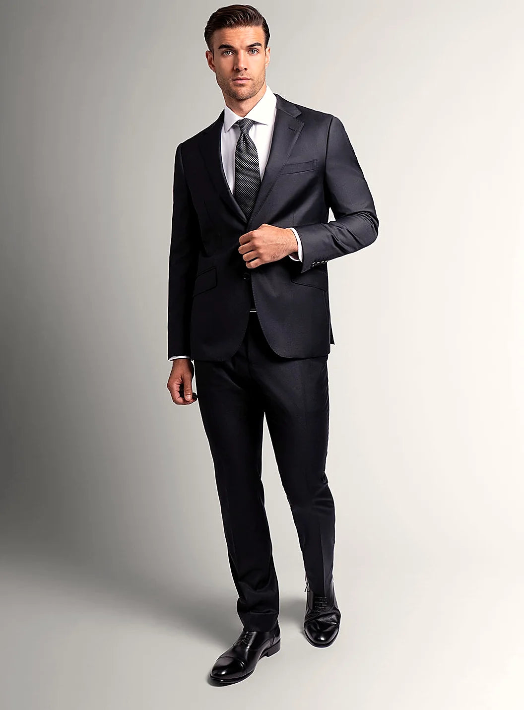 Angled view of the slim-fit black jacket