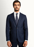 Navy twill suit jacket worn over a crisp shirt