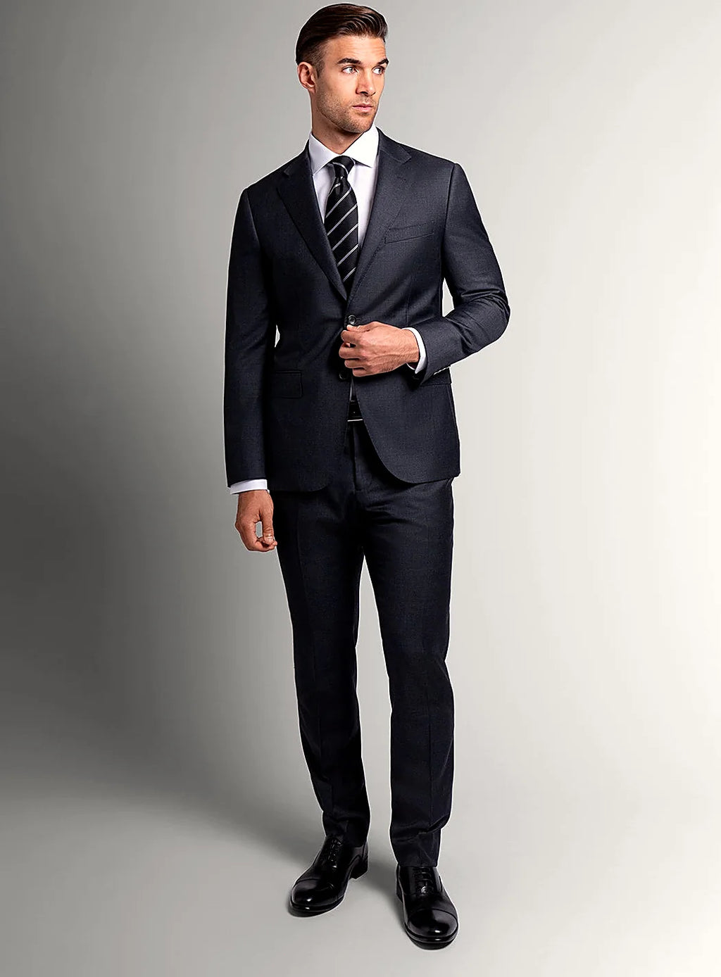 Angled view of the slim-fit charcoal jacket