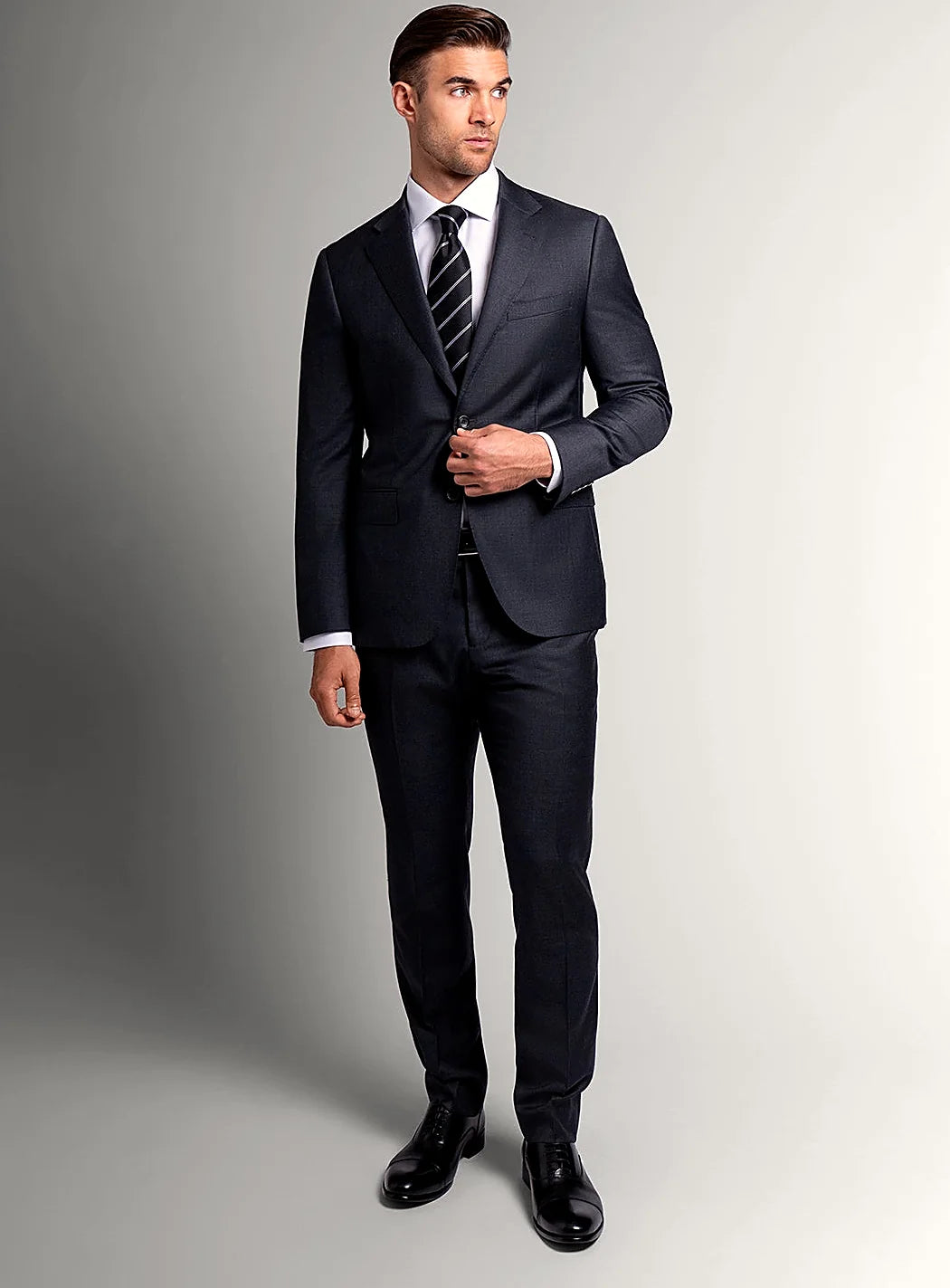 Angled view of the slim-fit charcoal jacket