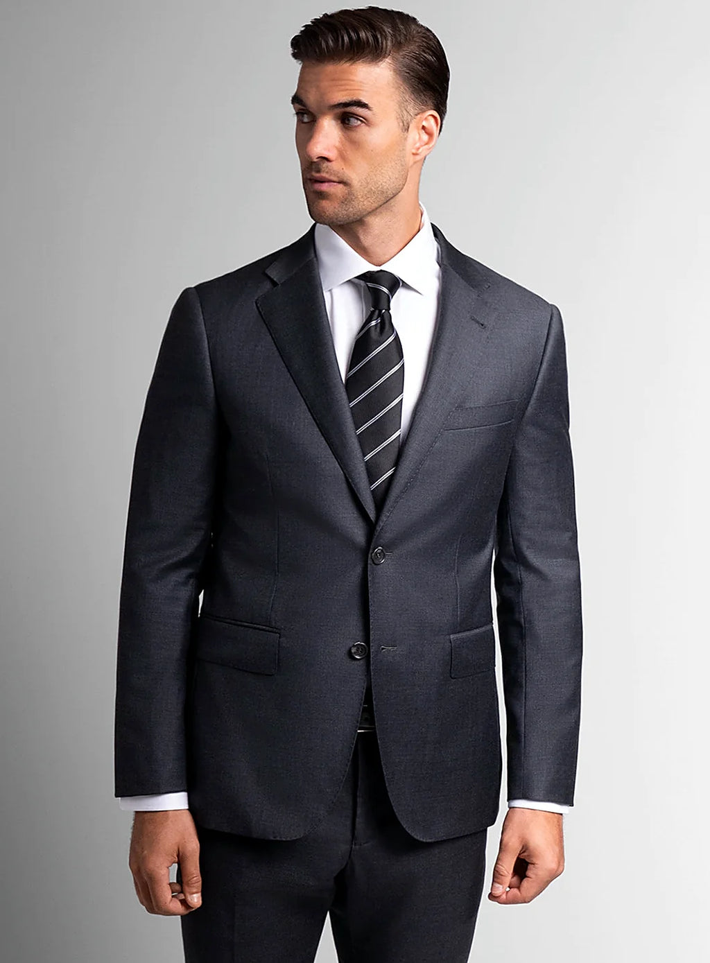 Lapel and chest pocket detail of the charcoal jacket