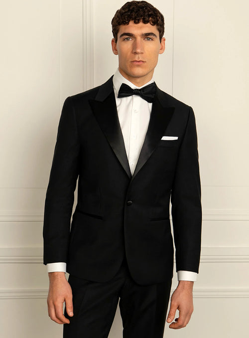 Black dinner suit worn full length with a formal shirt