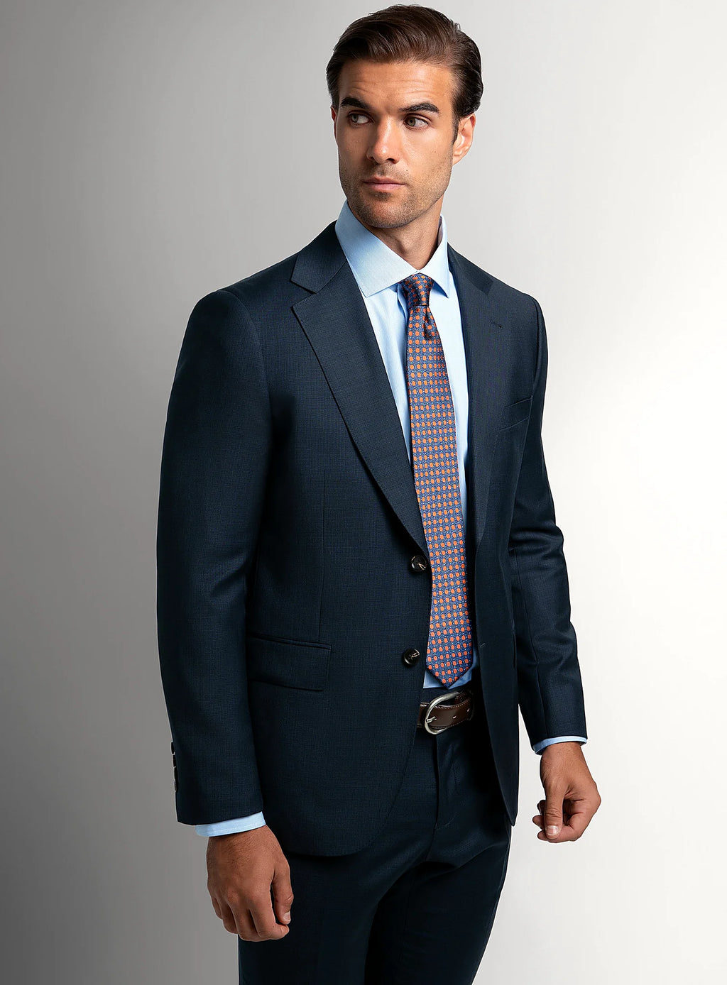 Notch lapel and flap pocket detail of the navy jacket