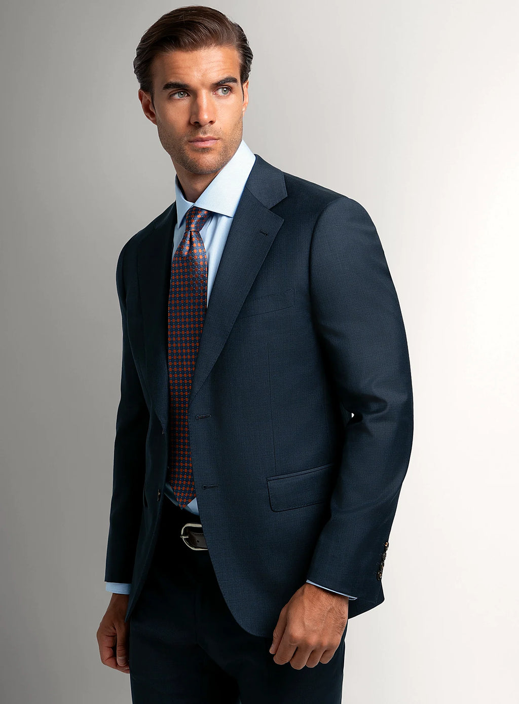 Navy micro-texture suit worn full length with a tie