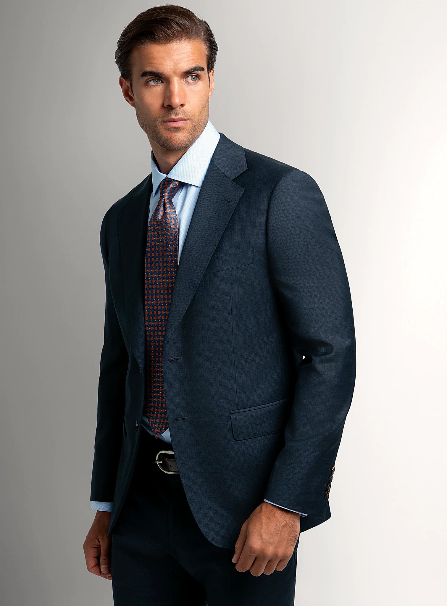 Navy micro-texture suit worn full length with a tie