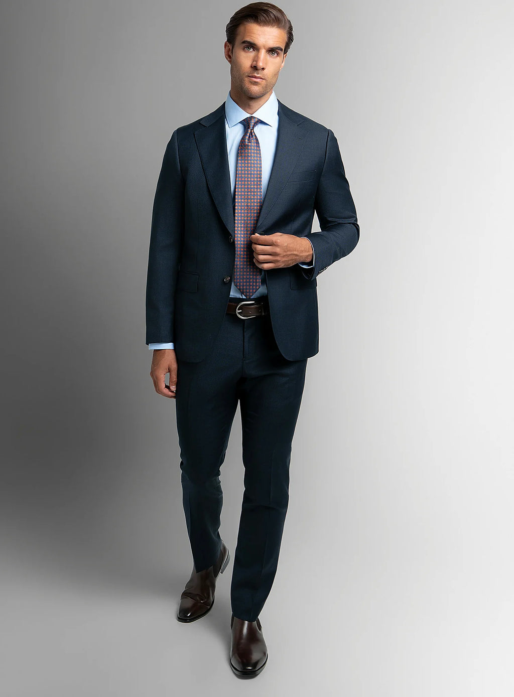 Three-quarter view of the navy jacket and trousers