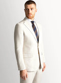 Sand linen blazer worn open over a pale shirt
