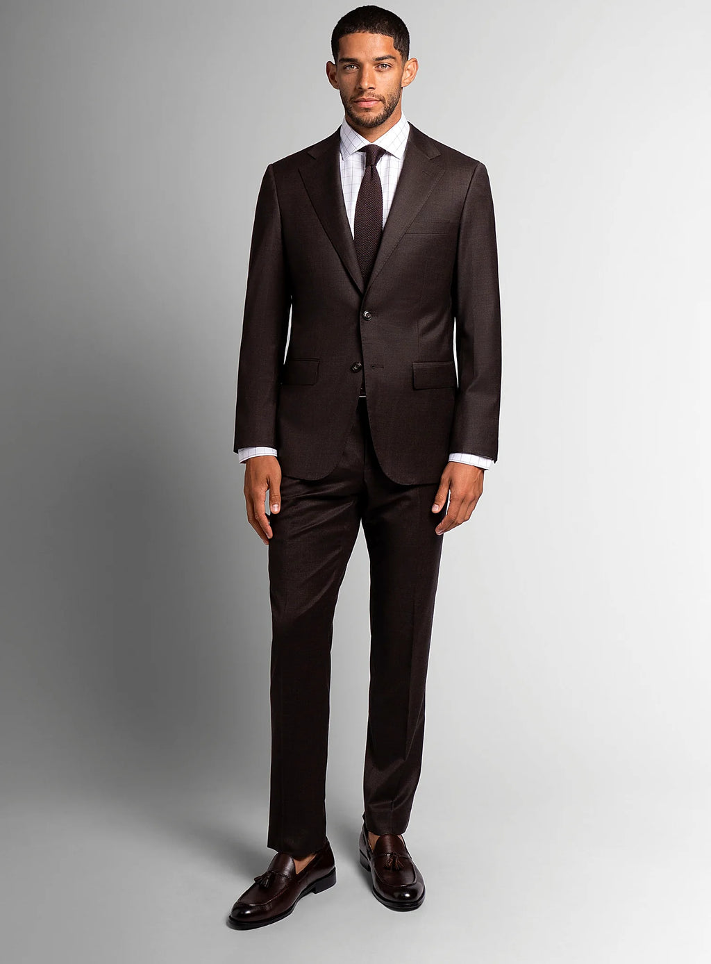 Angled view of the brown jacket and matching trousers