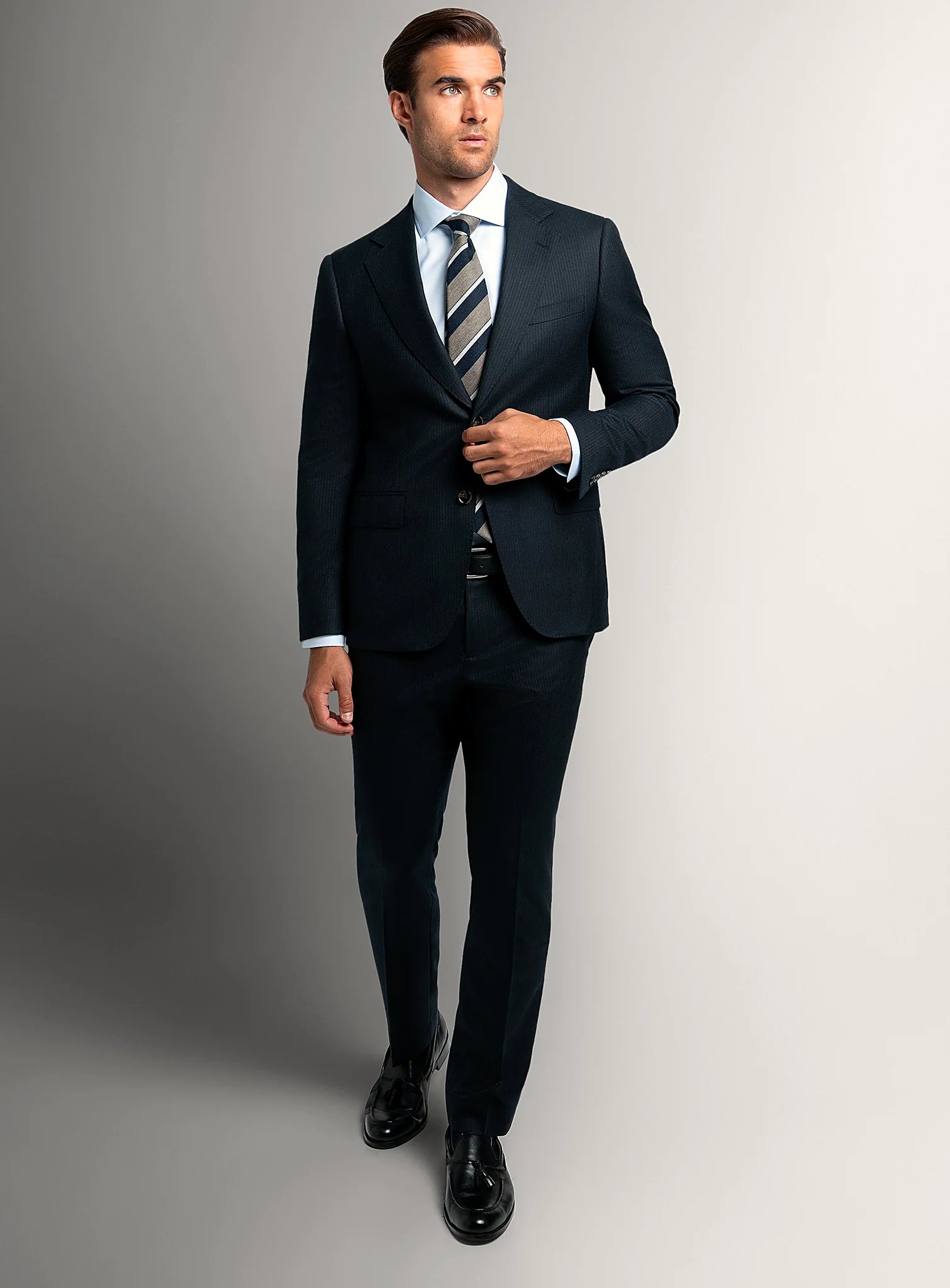 Angled view of the navy jacket and matching trousers