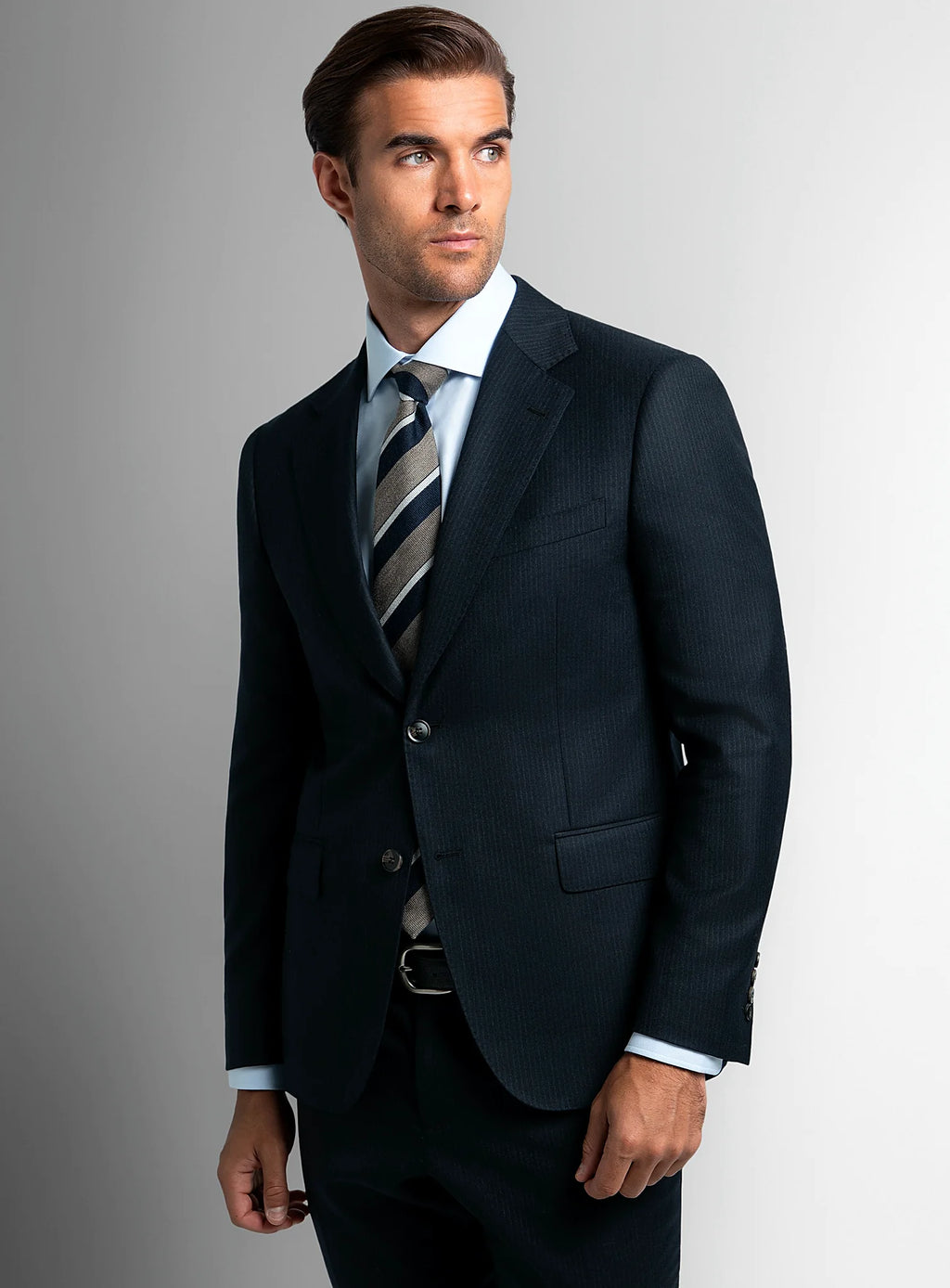 Navy flannel suit worn full length with a shirt and tie